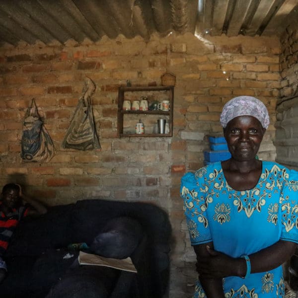 APRIL, 6, 2022: PHILOMINA RONGEDZAI (46) proudly stands inside her house, “Takunda yauya, ndakakwanisa kutenga ma bag 5 esemende ndikawedzera kukudza imba yangu nekuwedzera imwe room kuti aite matatu”, after joining Takunda, I managed to buy 5 bags of cement which helped me to extend my house and to add another room to make them three rooms using. Philomena used proceeds from her income generating activity. ©Sydney Saungweme/ CARE 2022