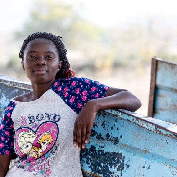 SEPTEMBER 14, 2021: MOREBLESSING TAMAYI (16) rests her arm on an overused cart in Buhera district. © Charmaine Chitate/ CARE.